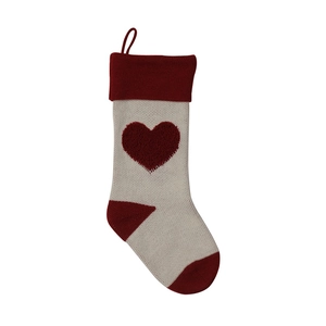 Detailed view of knitted Christmas stocking with red 3D heart pattern and loop hanger