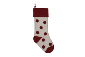 Détail d'une chaussette de Noël tricotée rouge et blanche avec pois 3D sur fond blanc