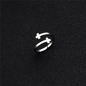 Close-up detail of silver stainless steel adjustable ring featuring double cross motifs
