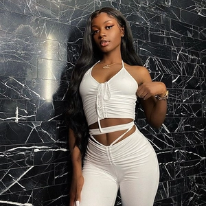 Detail of white halter neck crop top with drawstring and matching high waist trousers