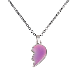 Macro shot of silver heart wing pendant with pink-purple glitter color-changing resin