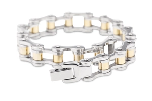 Detail of industrial bike chain bracelet in gold and silver polished stainless steel