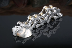 Detail of silver and gold stainless steel bike chain bracelet with reflective finish