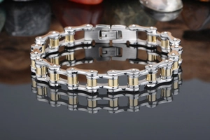 Macro view of two-tone gold and silver stainless steel motorcycle chain bracelet