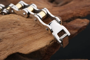 Detail of bicolor stainless steel bike chain bracelet with gold and silver finish