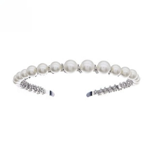 Detail of white pearl headband with sparkling rhinestones on a silver metal frame