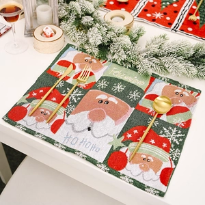 Christmas knitted placemat with Santa Claus motif and golden cutlery for table decor