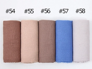 Detailed texture view of crinkled cotton scarves in colors numbered 54 to 58