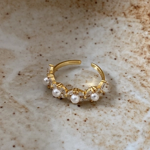 Close-up of S925 sterling silver hallmark on gold-plated pearl and zircon floral ring
