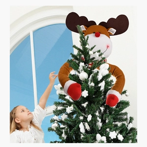 Detail of cute reindeer plush tree topper decoration with long arms hugging a Christmas tree