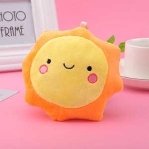Cute sun plush keychain with embroidered smiling face and orange rays on pink background