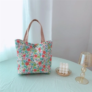 Detail of vintage floral canvas tote with metal snap button and cotton handles
