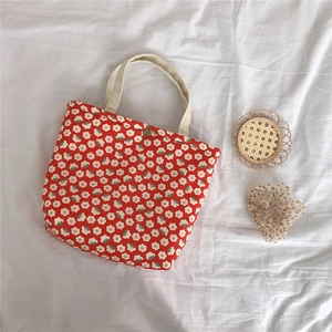 Detail shot of vintage floral insulated lunch bag with small white flowers and metal button