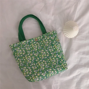 Close-up of vintage floral green canvas lunch bag with magnetic buckle and thick fabric