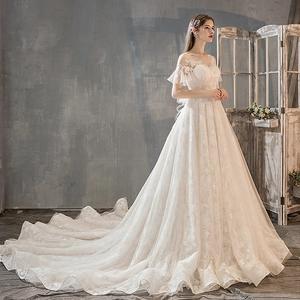 French ivory A-line wedding dress with floral lace embroidery and long cathedral train