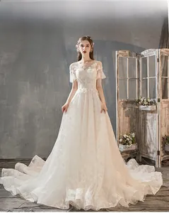 Detail of French style wedding dress with lace floral embroidery and elegant long train