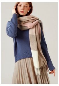 Detail of pink and beige plaid cashmere scarf fringe with soft knit texture