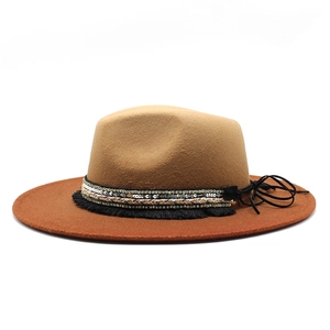 Detail of bohemian fedora with camel crown, red brim, and braided sequin band