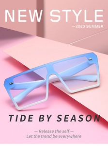 Close-up of blue gradient frameless sunglasses on a pink geometric fashion background