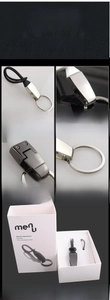 Detail of premium black titanium keychain with zinc alloy clip and branded gift packaging
