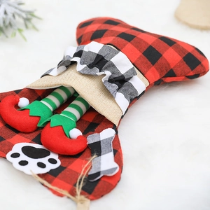 Bone-shaped Christmas stocking with red black plaid and festive elf legs decoration