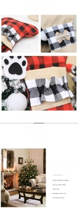Detail of burlap Christmas bone stocking with plaid patterns and black paw print applique