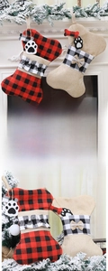 Close-up of bone-shaped burlap Christmas stockings with plaid accents and paw prints