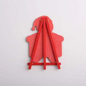 Red wooden Santa Claus ornament on a tripod stand for minimalist Christmas decoration