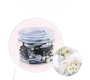 Detailed set of blue and black elastic hair bands with pearls and bow in a clear jar