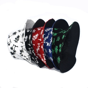 Detailed close-up of multiple colorful reversible bucket hats with palm tree prints