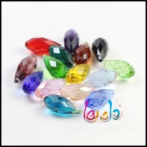 Close-up of faceted teardrop glass crystal beads in vibrant assorted rainbow colors