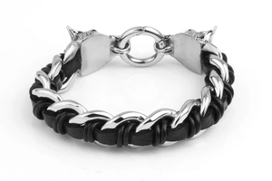 Detail of woven black leather bracelet featuring double wolf head steel clasps