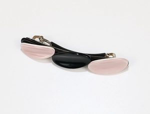 Detailed side view of acetate hair clip with triple oval pink and black geometric pattern