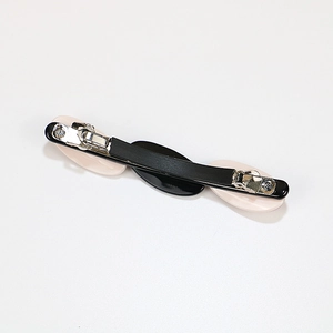 Minimalist acetate hair clip featuring oval geometric blocks in black and beige design
