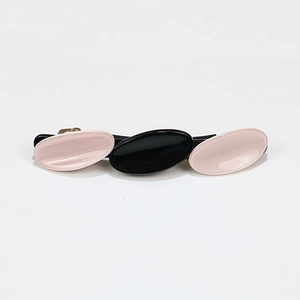 Three-link oval acetate geometric hair clip in pink and black for ponytail styling