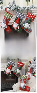 Detailed view of three festive gnome Christmas stockings hanging on a white fireplace mantle