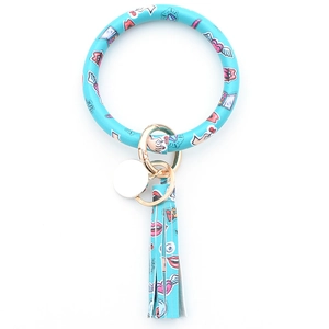 Close-up of light blue PU leather key ring bracelet with tassels and gold hardware