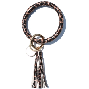 Detail view of leopard print PU leather keychain bracelet with golden clip and fringe tassel