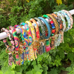 Detail of colorful PU leather tassel bracelets and keyrings with various patterns