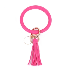 Close-up of pink PU leather wristlet keychain with golden ring and tassel detail