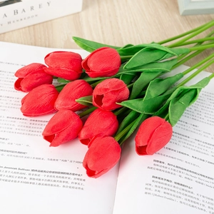 Detail of ten red artificial tulips with realistic texture on a magazine page background