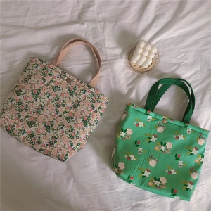 Detailed view of floral canvas lunch bags with cotton insulation and snap buttons
