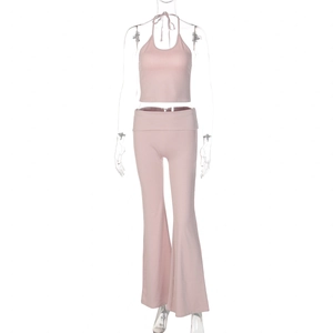 Detail view of pink halter crop top and high-waisted flared pants on a mannequin