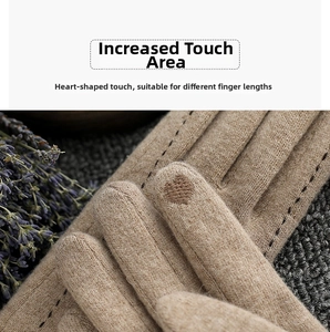 Close-up of heart-shaped touchscreen fingertip on warm khaki wool knit gloves
