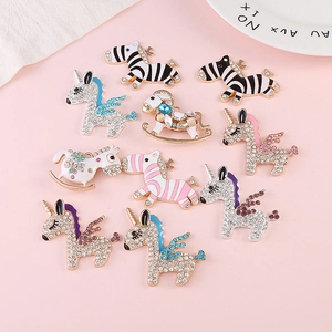 Detail view of crystal zebra and unicorn alloy charms for DIY craft jewelry making