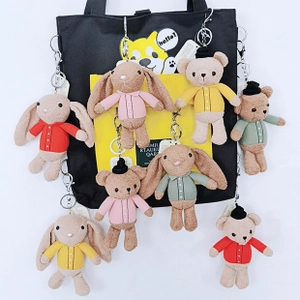 Cute sherpa fleece bunny and bear keychains with colorful button shirts on a tote bag