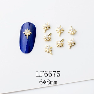 Détail du lot de 7 bijoux d'ongles en forme d'étoile dorée avec perles et nail art bleu