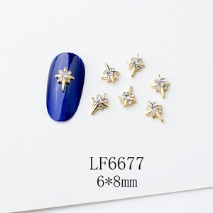 Détail de breloques à ongles croix dorées 6x8mm avec perles et strass sur base bleue