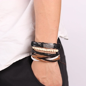Handmade multilayer leather bracelet set with wing pendant and wooden beads on wrist
