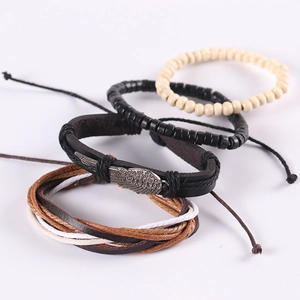 Multilayer leather bracelet set with wing charms and wooden beads in vintage style